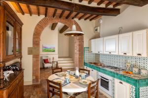 a kitchen with a table and chairs in a room at Villa Pianoia in Montepulciano