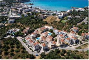 an aerial view of a city with the ocean at Palm Tree Villa in Almirida