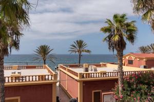 a view of the ocean from the balcony of a house at Villa Las Americas in Playa de las Americas