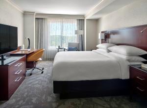 a large hotel room with a large bed and a desk at Atlanta Airport Marriott Gateway in Atlanta