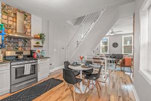 a kitchen and living room with a table and chairs at Trendy Family Friendly Northern Liberties Retreat in Philadelphia