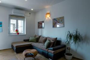 a living room with a couch and a table at Deluxe Apartment and Studio "Nona Fa" in Rijeka