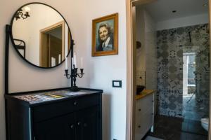 a bathroom with a black dresser and a mirror at Deluxe Apartment and Studio "Nona Fa" in Rijeka