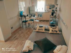 a room with a kitchen and a living room with a couch at SCACCO MATTO Holiday House in Taranto