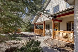 a house with a porch with a deck at Cozy Arizona Retreat with Fireplace, Patio and Grill! in Flagstaff