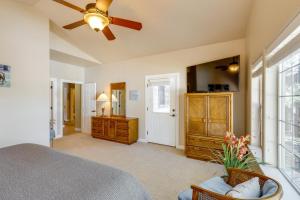 a bedroom with a bed and a ceiling fan at Cozy Arizona Retreat with Fireplace, Patio and Grill! in Flagstaff