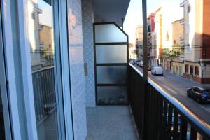 a balcony with a view of a city street at Apartamento PLAYA 5 minutos a pie MODERNO Y CONFORTABLE CABANYAL in Valencia