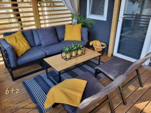 a patio with a couch and a table and chairs at PAMARA Mobile Home in Biograd na Moru