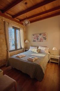 a bedroom with a bed and a large window at MintHouse Holiday Home in  Episkopi (Chania)
