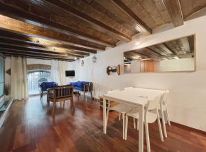 a dining room with a white table and chairs at Stay U-nique Apartments Plaça Universitat in Barcelona