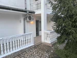 a white house with a white railing and a staircase at Sunny Beach Apartment - Kuban / Bravo 5 in Sunny Beach