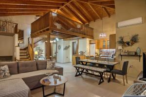 a living room with a couch and a table at MintHouse Holiday Home in  Episkopi (Chania)