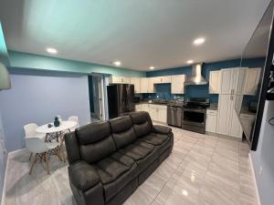 a living room with a couch and a table at Atlantic Shores Motel in Daytona Beach