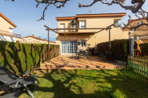 a house with a fence and a patio at RNET - Port Estrella 31 - Roses Costa Brava in Roses