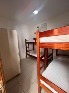 a room with two bunk beds and a refrigerator at Rio 222 Hostel in Rio de Janeiro