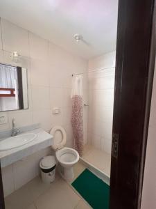 a bathroom with a toilet and a sink at Rio 222 Hostel in Rio de Janeiro