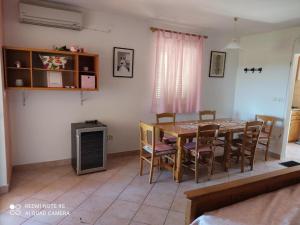 a dining room with a table and chairs at Apartments Nino in Štivan