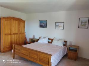 a bedroom with a large bed and a wooden cabinet at Apartments Nino in Štivan