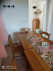 a wooden dining room table with chairs and a table sidx sidx sidx at Apartments Nino in Štivan
