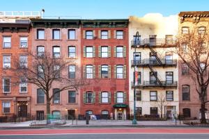 a large red brick building on a city street at Chelsea Pines Inn in New York