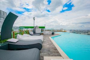 a swimming pool on the roof of a building at Léman Luxury Apartment District 3 HCMC in Ho Chi Minh City