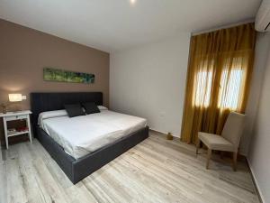 a bedroom with a bed and a desk and a chair at ACENI in Ciudad Real