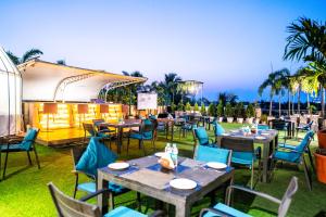 an outdoor dining area with tables and chairs at Hotel Pal Heights in Bhubaneshwar