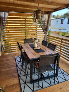 a dining room table and chairs on a deck at PAMARA Mobile Home in Biograd na Moru