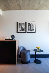 a room with a blue chair and a table at The Londoner Hotel Sliema in Sliema