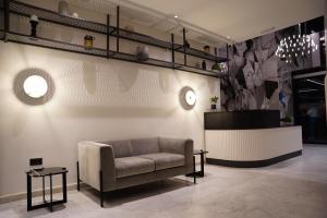 a living room with a couch and a table at The Londoner Hotel Sliema in Sliema