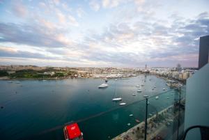 a view of a harbor with boats in the water at The Londoner Hotel Sliema in Sliema