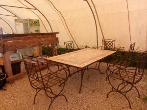 a wooden table and chairs in a tent at Canadienne in Le Fay