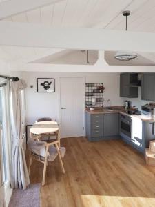 a kitchen with a table and a kitchen with a tableablish at The Lodge in High Legh