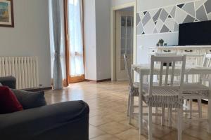 - un salon avec une table et des chaises blanches dans l'établissement La Casa del Nonno, à Omegna