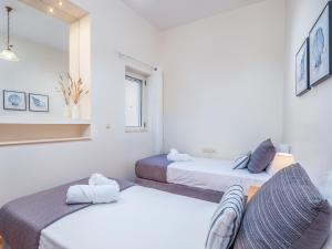 a room with two beds and a couch in it at Casteli Stone Residence in Kissamos