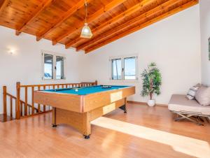 a living room with a pool table in it at Casteli Stone Residence in Kissamos