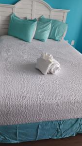 a bed with a pile of towels on it at Breakers Resort in Myrtle Beach +30 photos