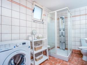 a bathroom with a washing machine and a shower at Casteli Stone Residence in Kissamos +23 photos