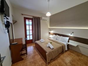 a bedroom with a large bed with towels on it at Zigos Apartments in Igoumenitsa