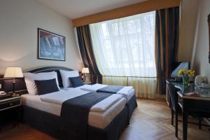 Posteľ alebo postele v izbe v ubytovaní Elysee Hotel