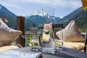 a glass vase sitting on top of a table at Huber's Boutique Hotel in Mayrhofen