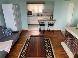 a kitchen with a table and some chairs in a room at Seafront house in Swakopmund