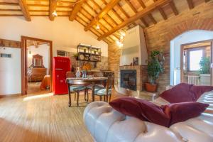 sala de estar con sofá de cuero y mesa en Casale Vincenzo Country House, en Collecorvino