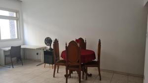 a dining room with a table and chairs and a desk at HOSTEL SANTOS PRAIA in Santos +7 photos