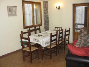 a dining room with a table and chairs at Casa nel bosco alle Macinaie in Monte Amiata