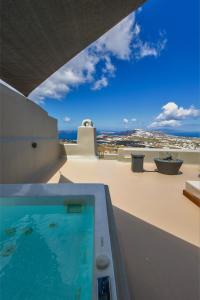 a swimming pool on the roof of a house at Luna Santorini Suites in Pyrgos