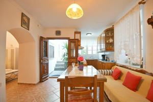 a living room with a couch and a table at Maria's House in Hydra