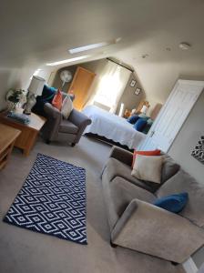 a living room with a bed and a couch at Apartments at Ballinsheen House & Gardens in Lisdoonvarna