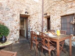 a wooden table and chairs on a patio at NICE HOUSE in VILA VELLA TOSSA DE MAR in Tossa de Mar