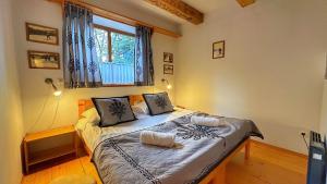 - une chambre avec un lit dans une pièce dotée d'une fenêtre dans l'établissement Apartamenty Pod Cisówką, à Zakopane